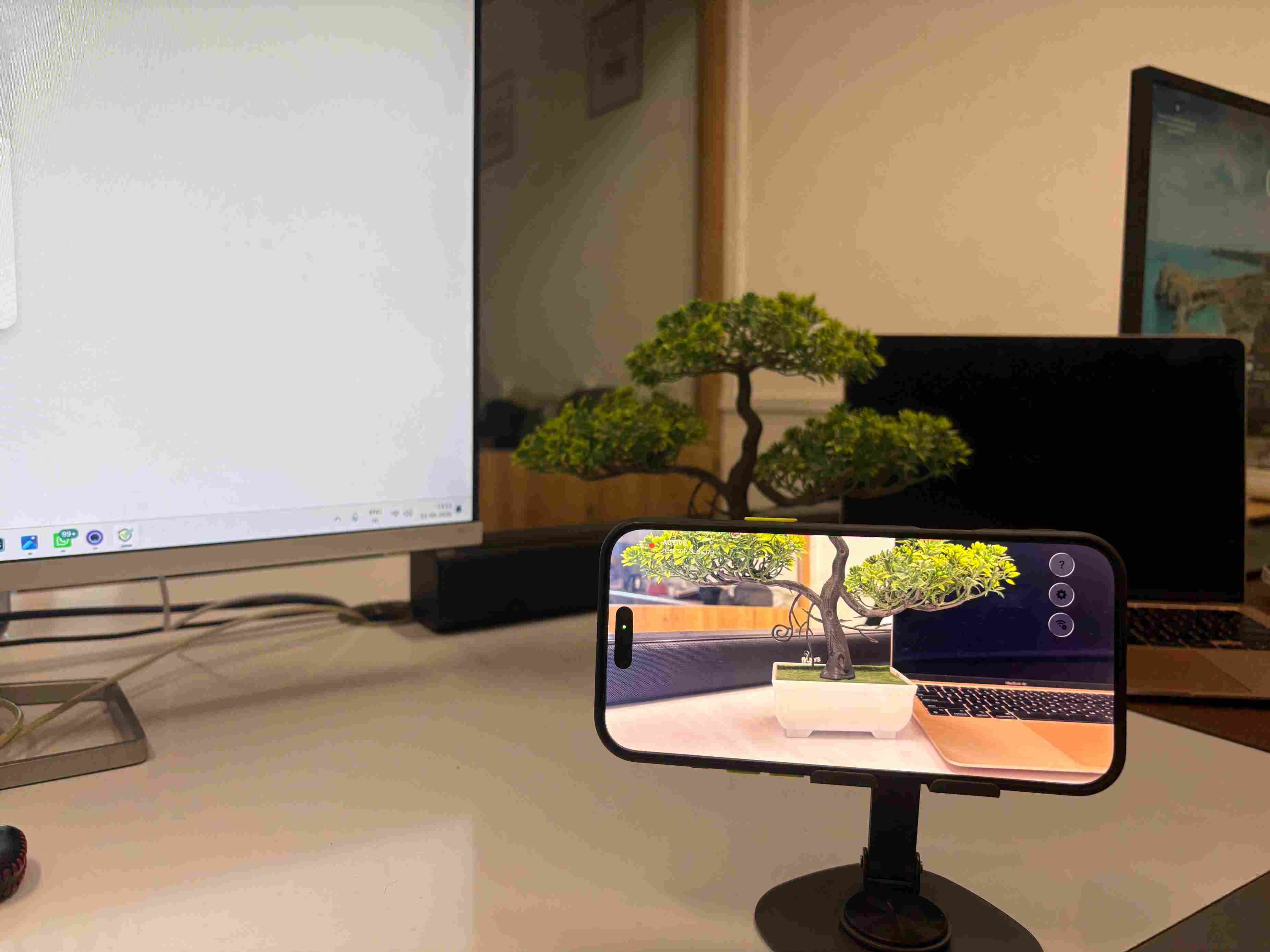 Phone paired over Wi-Fi and streaming, with the live camera view on its screen