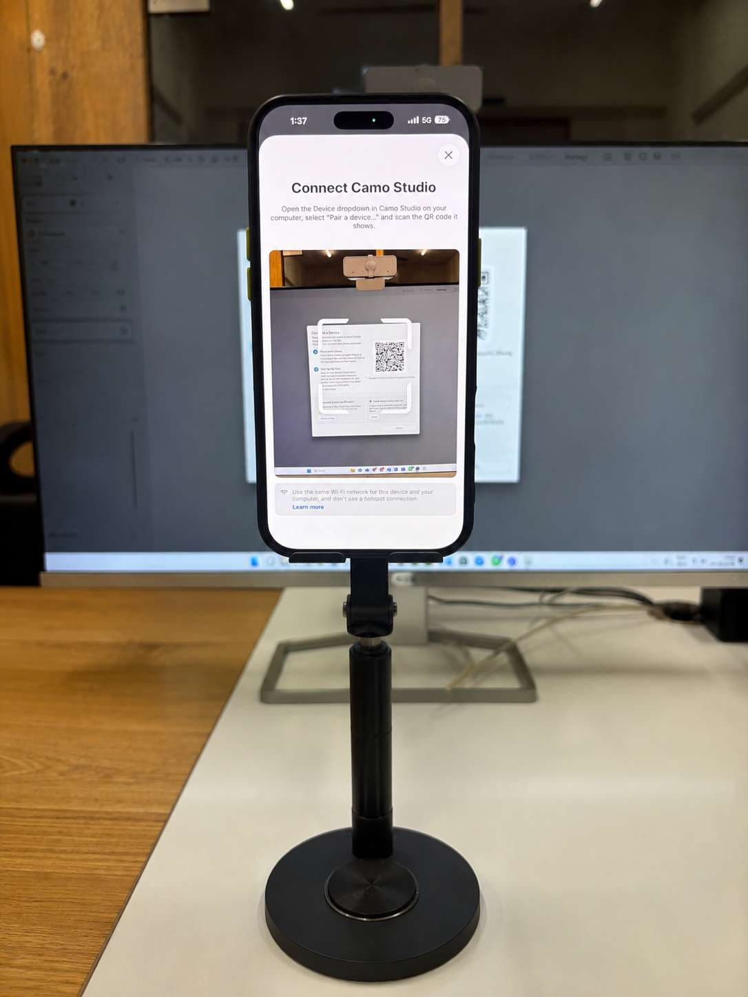 The Camo app scanning the pairing QR code shown by Camo Studio on the monitor